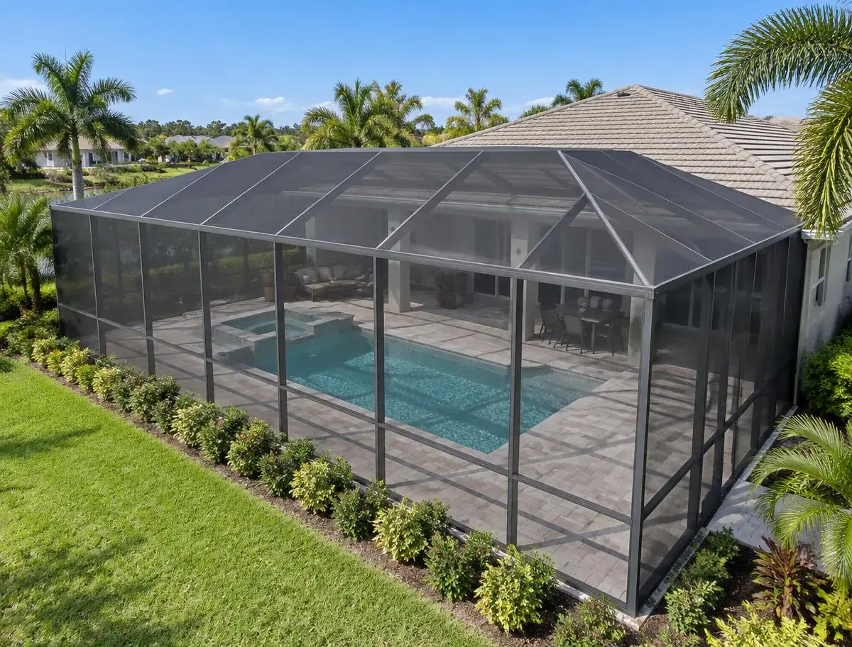 Elevated view of a fully screened pool cage with uniform mesh on walls and roof